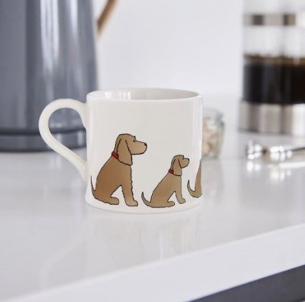 white mug with a golden spaniel on the side of it.