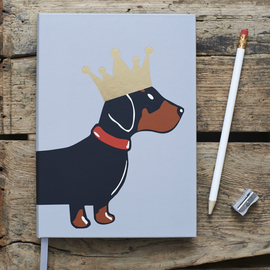 Notebook with a dachshund illustration wearing a crown. New Zealand